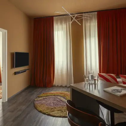 a room with a table and chairs and a tv