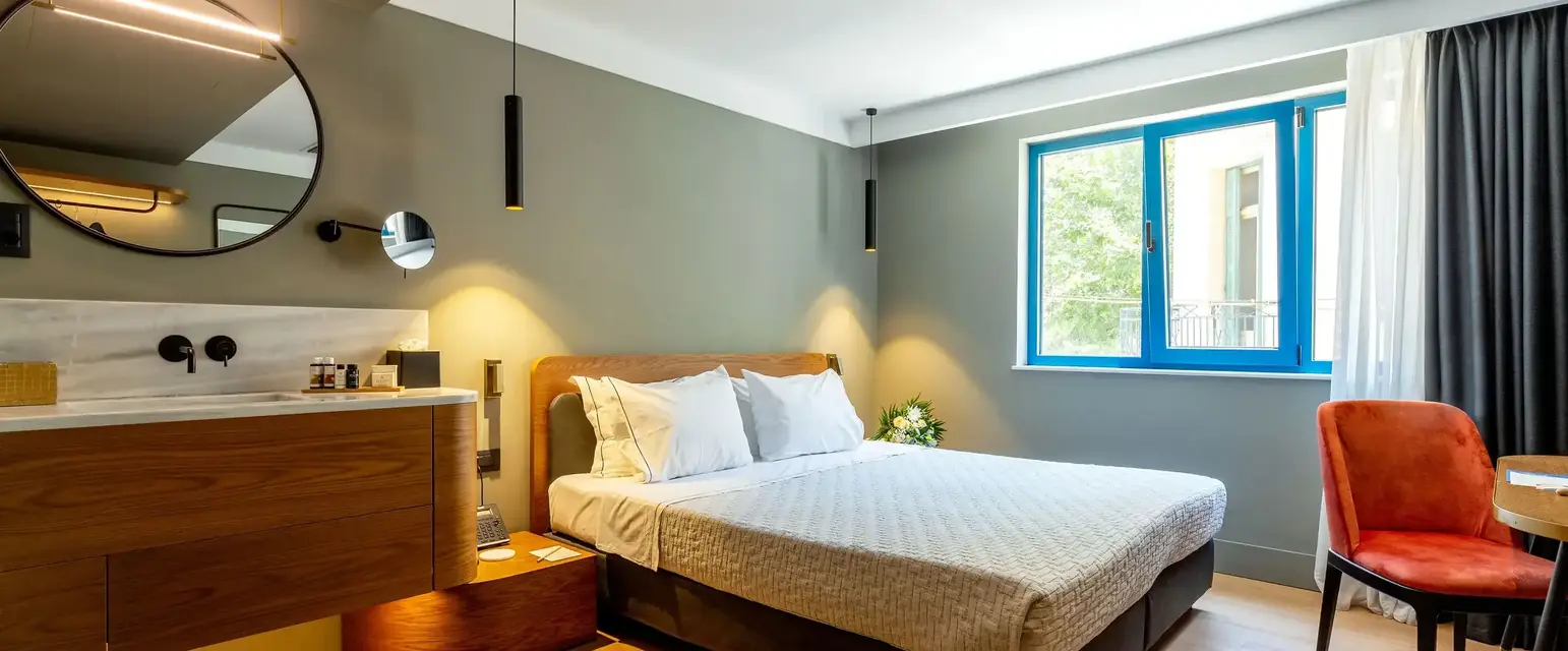 a bedroom with a mirror and a bed