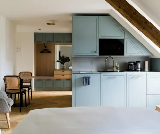 a kitchen with a bed and a table