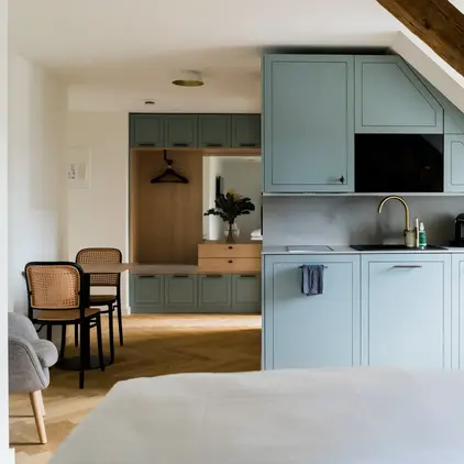 a kitchen with a bed and a table