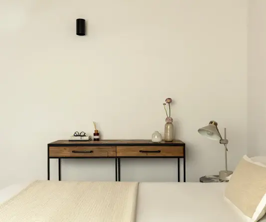 a bed with a table and lamp
