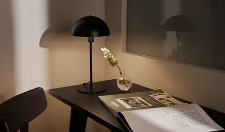 a table with a lamp and a vase on it