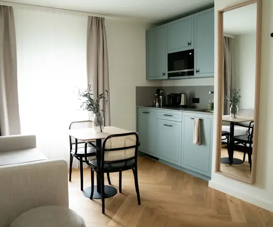 a kitchen and dining area with a table and chairs