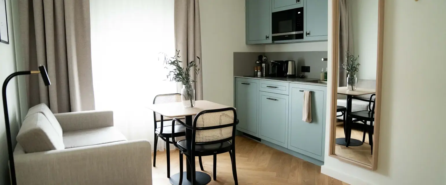 a kitchen and dining area with a table and chairs