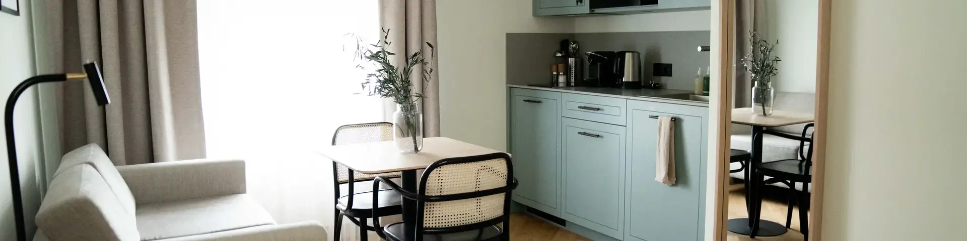 a kitchen and dining area with a table and chairs
