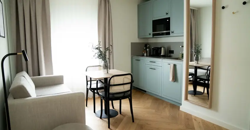 a kitchen and dining area with a table and chairs