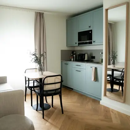a kitchen and dining area with a table and chairs