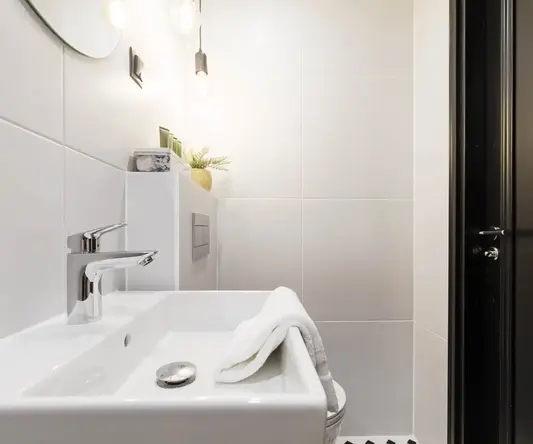 a white bathroom with a sink and a mirror