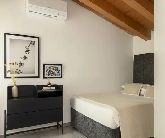 a room with a bed and a dresser
