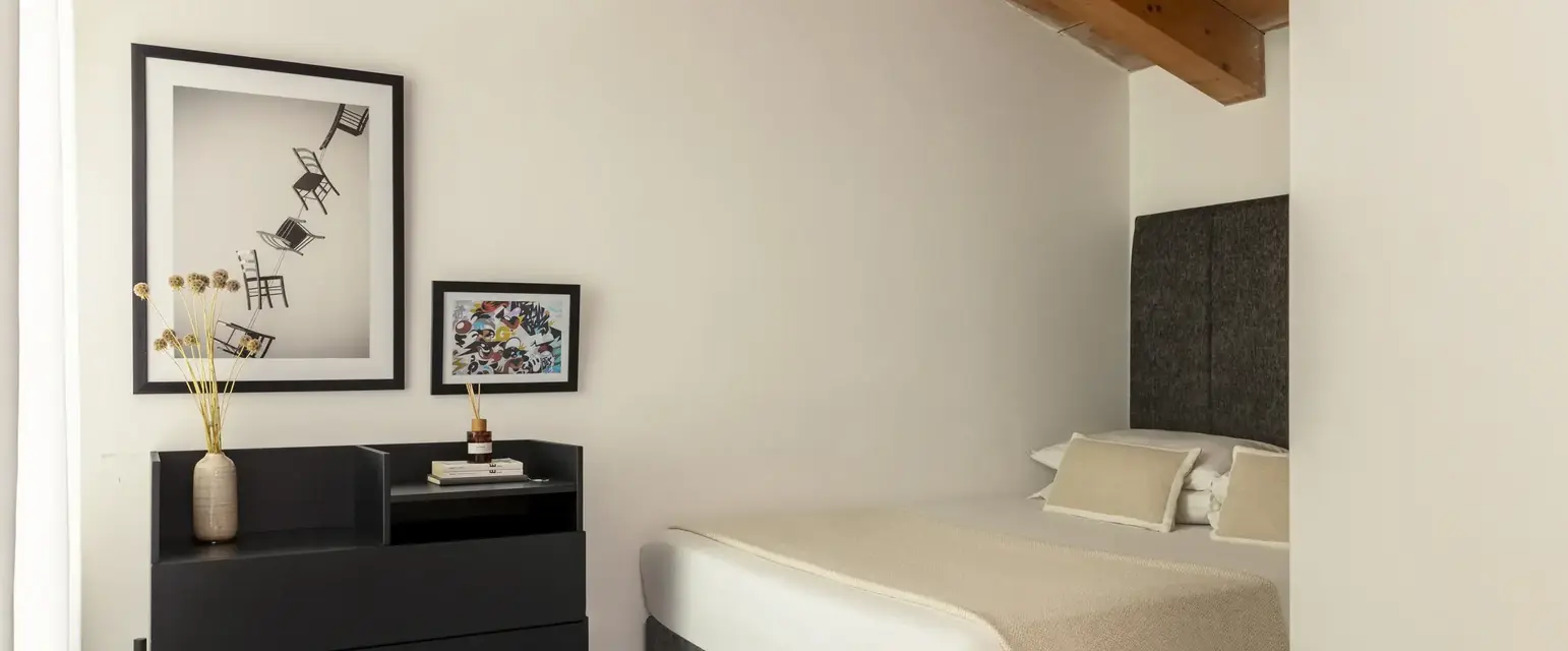 a room with a bed and a dresser