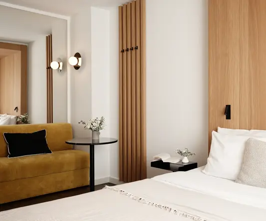 a bedroom with a bed and a couch