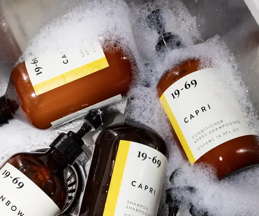 a group of brown bottles in a sink full of bubbles