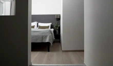 a bedroom with a bed and a plant