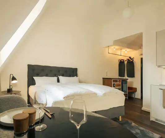 a bedroom with a bed and a table