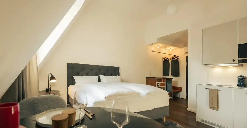 a bedroom with a bed and a table