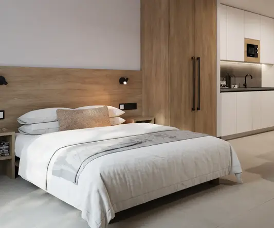 a bedroom with a bed and a microwave