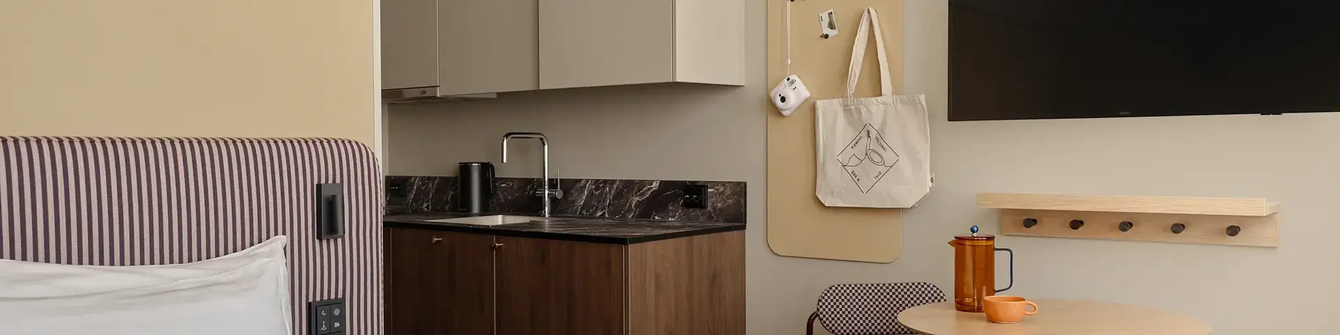 a room with a bed and a table and a tv