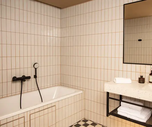 a bathroom with a bathtub and a mirror