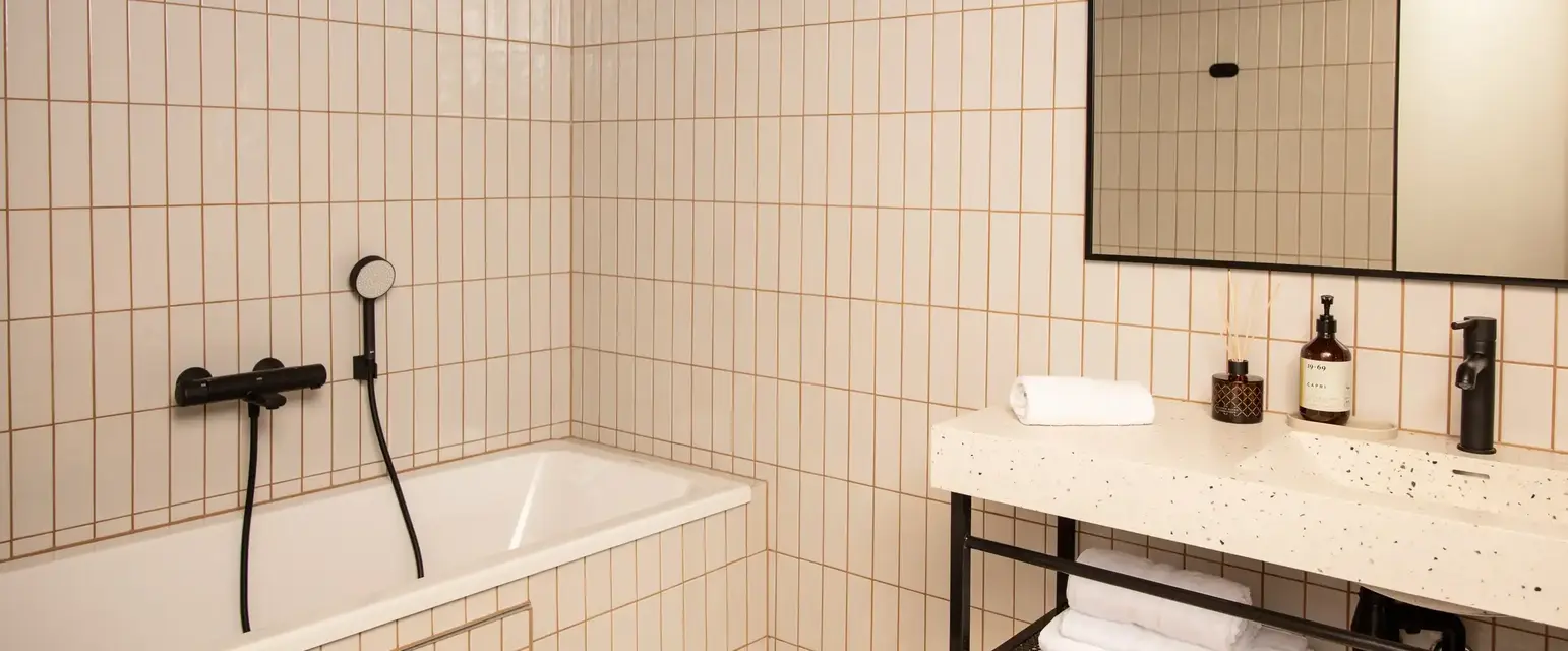 a bathroom with a bathtub and a mirror