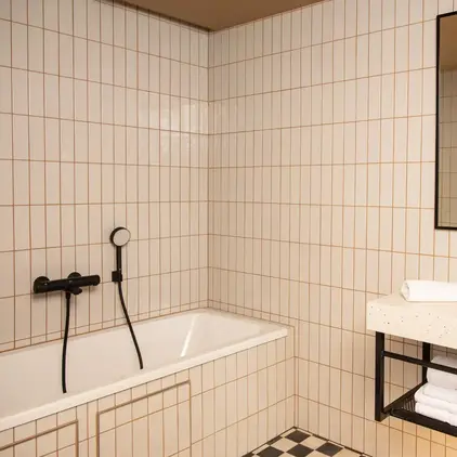 a bathroom with a bathtub and a mirror