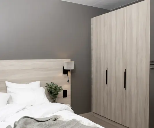 a bed with a plant in front of it