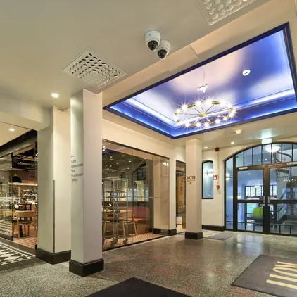 a building with glass doors and a blue ceiling