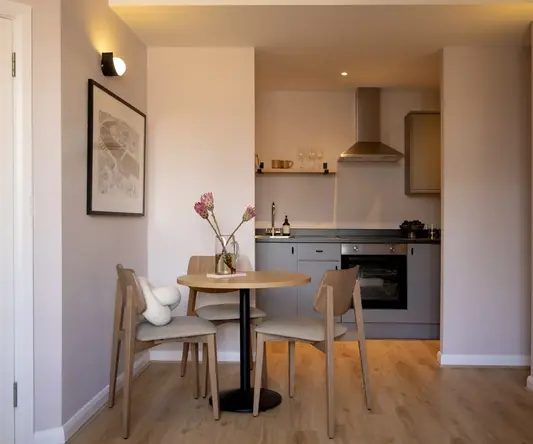 a kitchen with a table and chairs