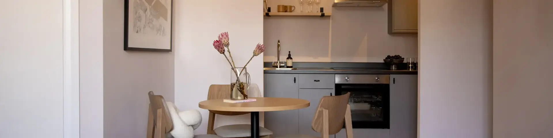 a kitchen with a table and chairs
