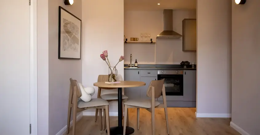 a kitchen with a table and chairs
