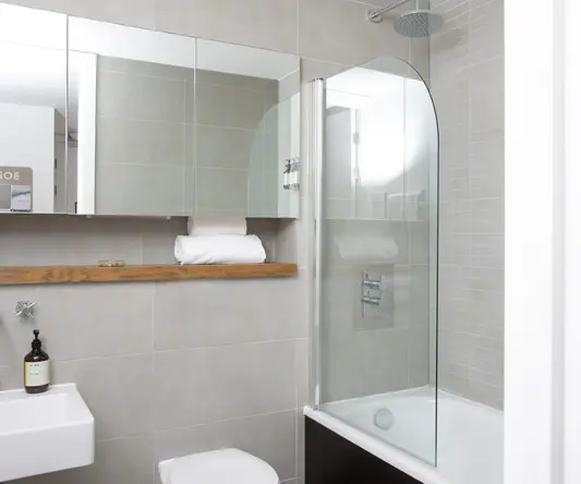 a bathroom with a glass shower and a toilet