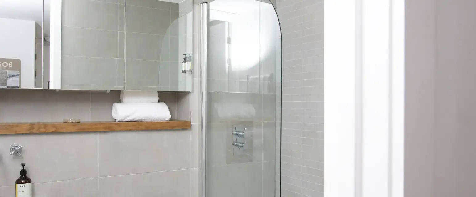 a bathroom with a glass shower and a toilet