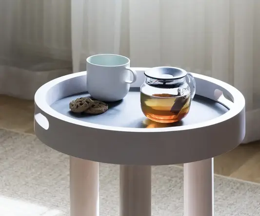 a coffee cup and cookie on a small table