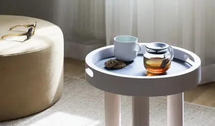a coffee cup and cookie on a small table
