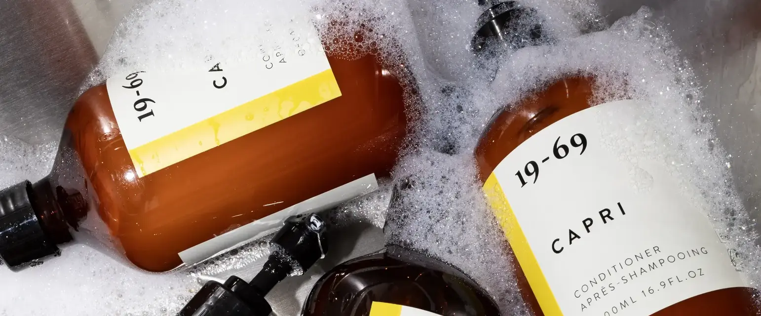 a group of brown bottles in a sink full of bubbles