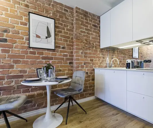 a kitchen with a table and chairs