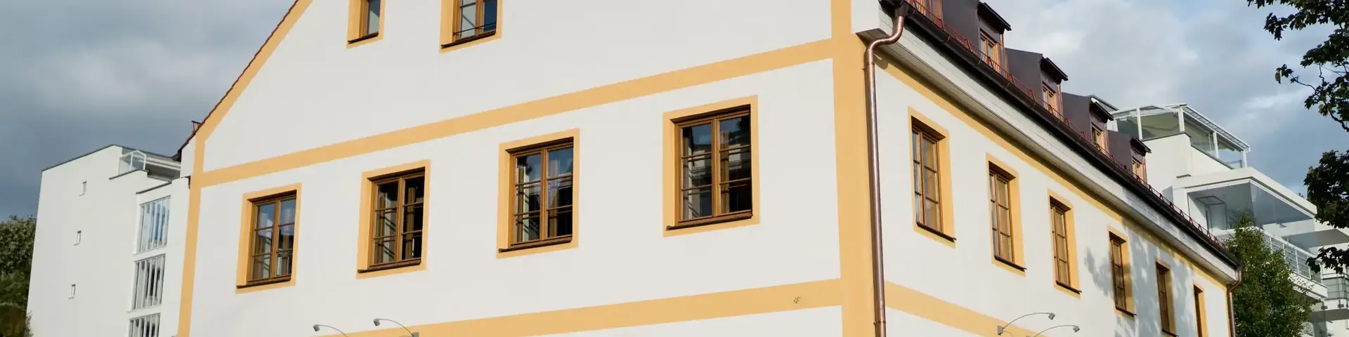 a white and yellow building with a fence