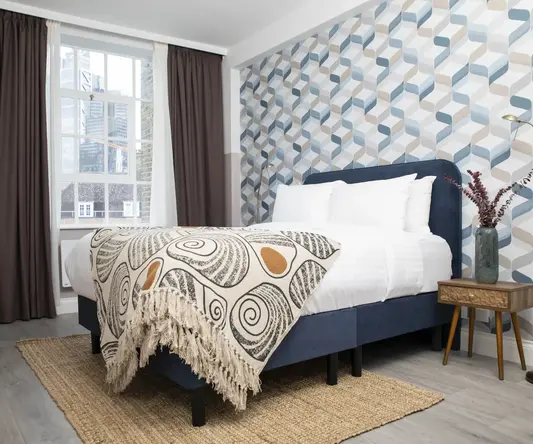 a bed with a blanket in a room