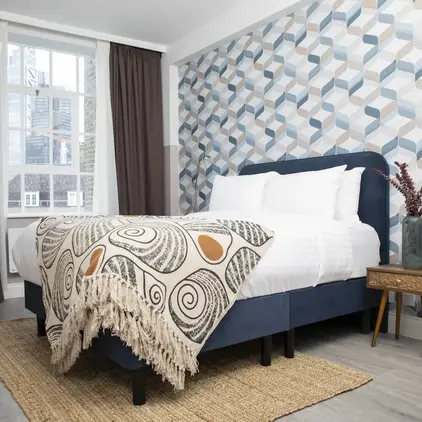 a bed with a blanket in a room