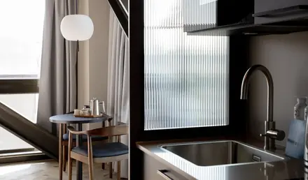 a kitchen with a sink and chairs