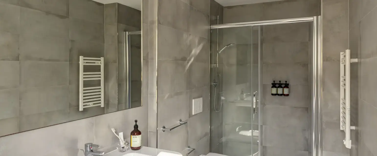 a bathroom with a shower and sink