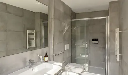 a bathroom with a shower and sink