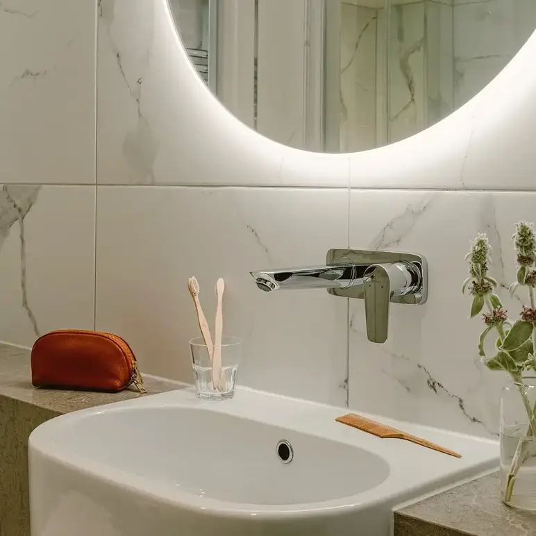 a bathroom with a round mirror