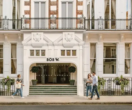 a group of people walking in front of a building