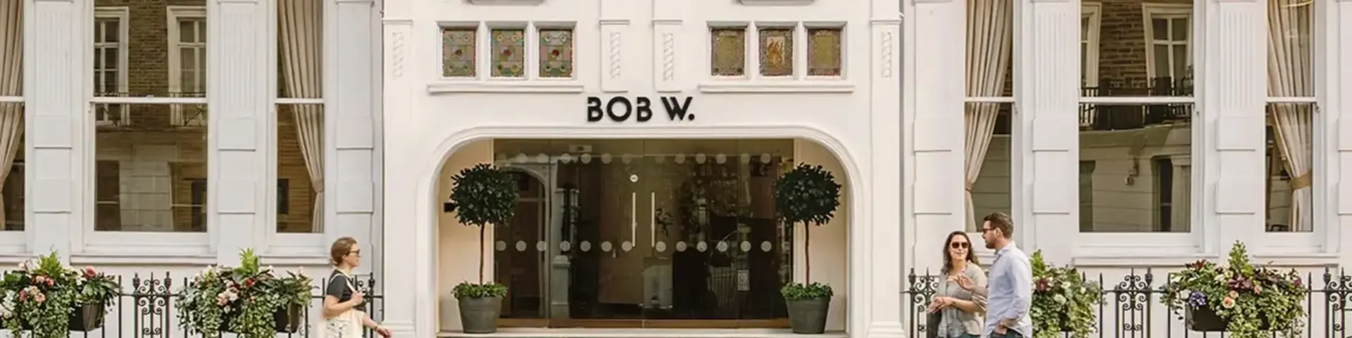 a group of people walking in front of a building