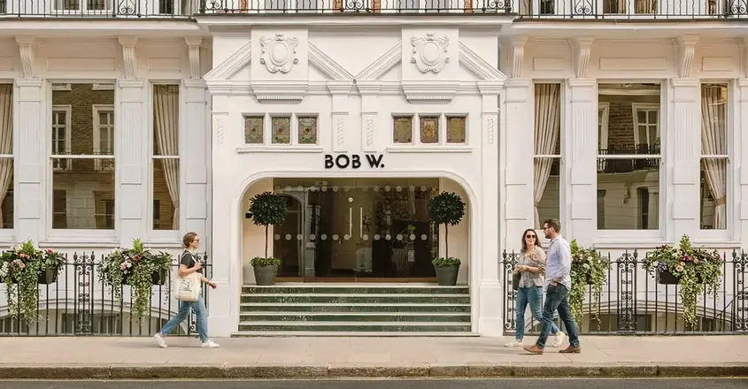 a group of people walking in front of a building