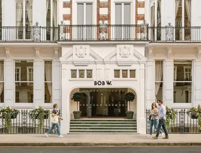 a group of people walking in front of a building