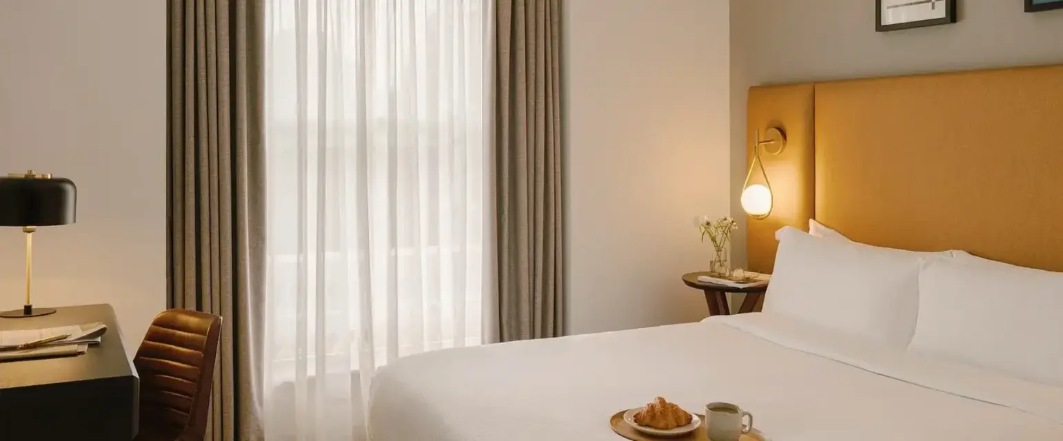 a bed with a tray of food on it