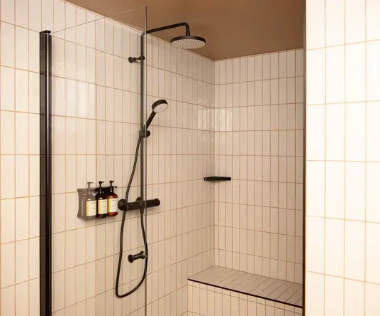 a shower with a black shower head