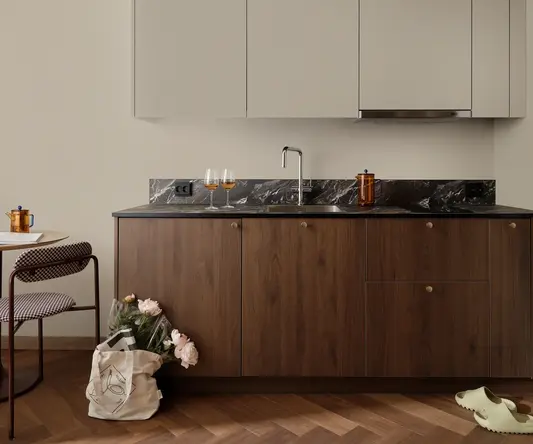 a kitchen with a sink and a bag of flowers