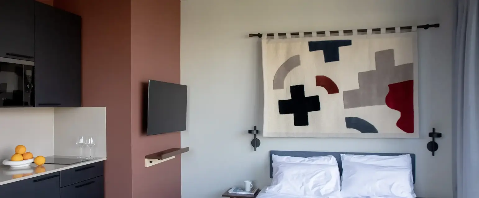 a bedroom with a bed and a tv